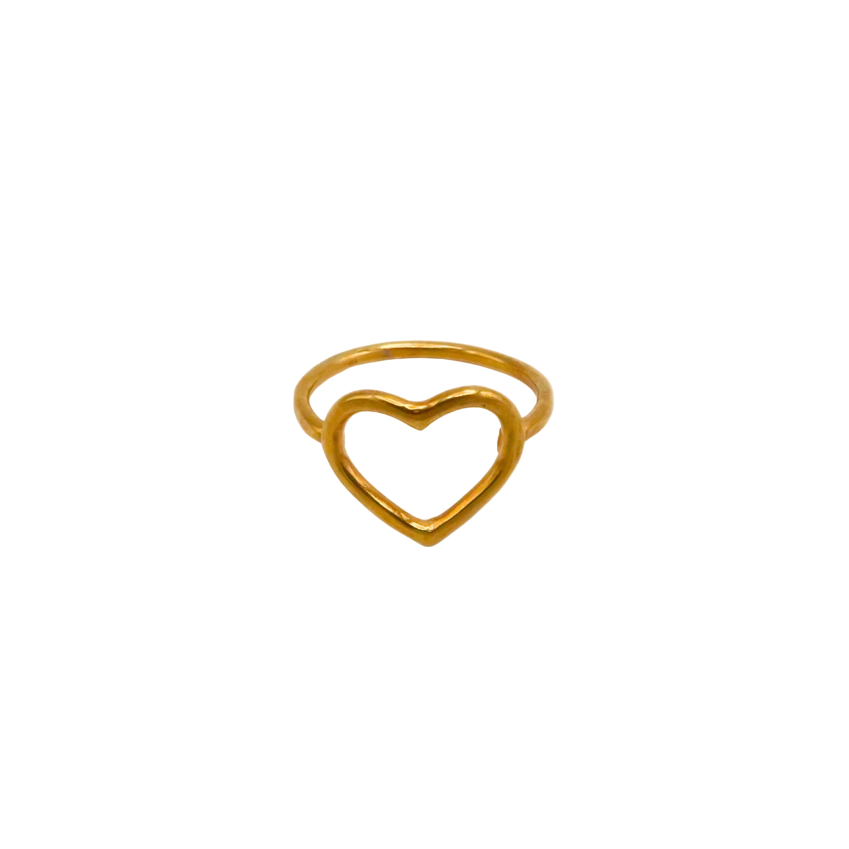 Gold heart-shaped ring on a light white background